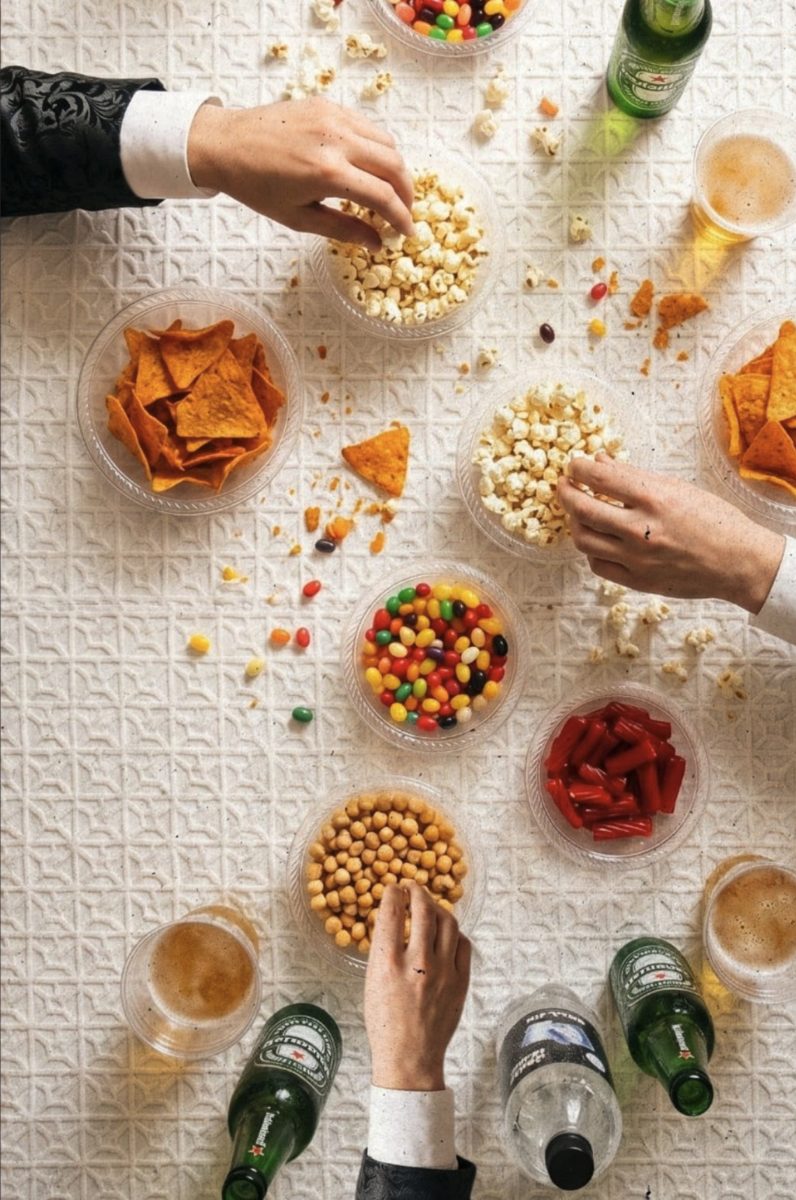 Student image: overhead table of snacks with hands reaching in